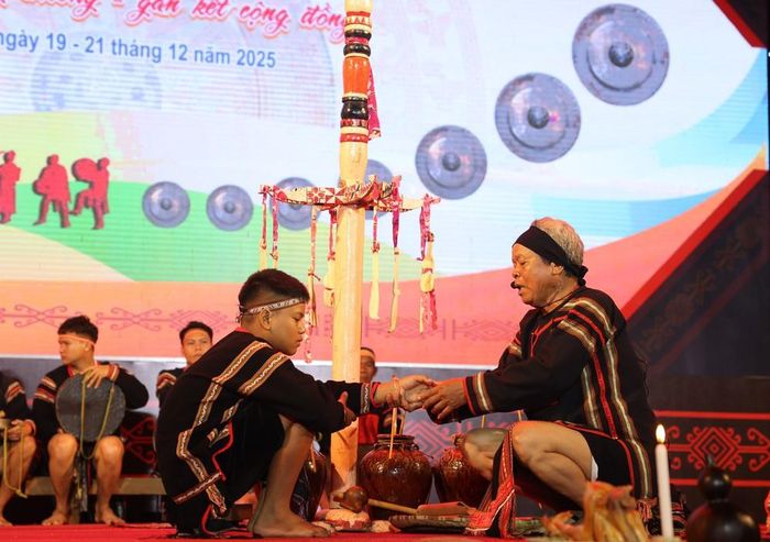 Thầy cúng đeo vòng tay cầu sức khỏe, may mắn cho trẻ em trong lễ Mừng tuổi cho trẻ em của đồng bào người Ê Đê. Ảnh: Tuấn Anh - TTXVN