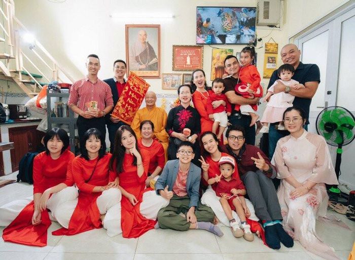 Các thành viên trong nhà diện áo dài đỏ, quây quần bên nhau trong ngày Tết.