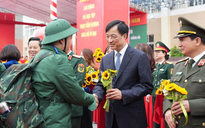 Bí thư Thành ủy Nguyễn Duy Ngọc tặng hoa động viên các tân binh. Ảnh: HNP