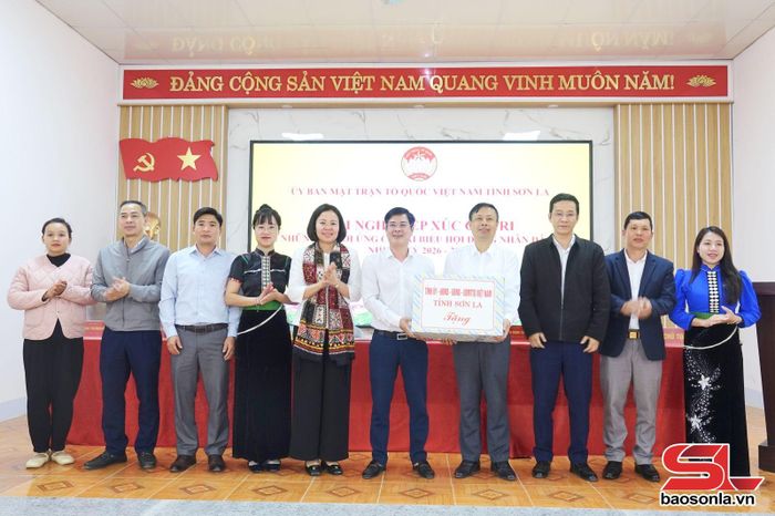 Đồng chí Hoàng Thị Đôi trao quà của Tỉnh ủy, HĐND, UBND, Ủy ban MTTQ Việt Nam tỉnh cho xã Chiềng La.