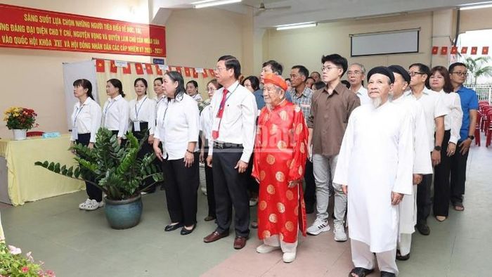 Nhà nghiên cứu Nguyễn Đình Tư (106 tuổi) mặc áo dài đỏ tham gia bầu cử sáng 15/3.