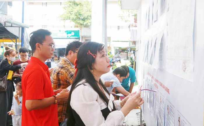 Cử tri nghiên cứu về thông tin của các ứng cử viên trước khi bỏ phiếu bầu. Ảnh: Văn Dũng