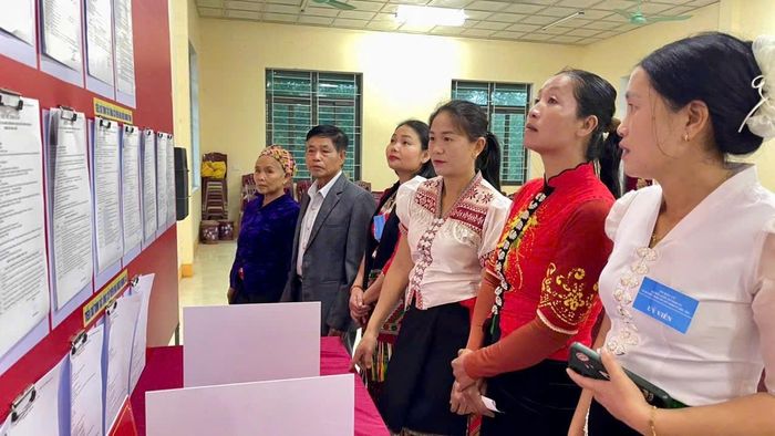 Cử tri xem danh sách và tiểu sử tóm tắt ứng cử viên trước giờ bỏ phiếu tại khu vực bỏ phiếu số 7