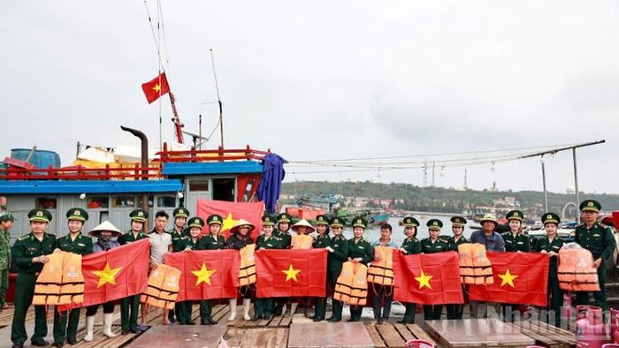  Hội phụ nữ Bộ đội Biên phòng thành phố Hải Phòng tặng cờ Tổ quốc và áo phao cho ngư dân. 
