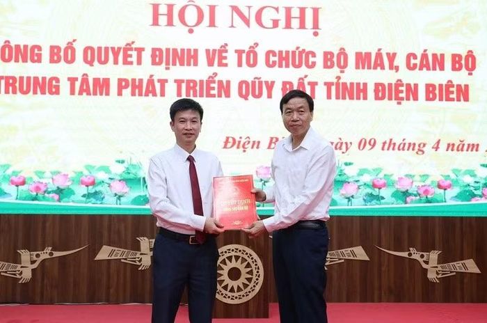 Đồng chí Lê Văn Lương, Chủ tịch Ủy ban nhân dân tỉnh Điện Biên (bên phải) trao quyết định bổ nhiệm Phó Giám đốc Trung tâm Phát triển quỹ đất tỉnh cho đồng chí Trần Quốc Long.