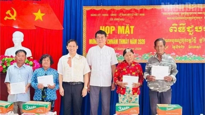 Chủ tịch Ủy ban nhân dân xã Vĩnh Hậu Trần Hoàng Khải (thứ ba, từ trái sang) tặng quà Tết đồng bào Khmer hoàn cảnh khó khăn và người Khmer có uy tín của xã.