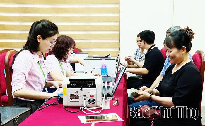 Cán bộ Phòng giao dịch Ngân hàng Chính sách xã hội Lập Thạch giải ngân nguồn vốn vay ưu đãi cho người dân xã Tiên Lữ.