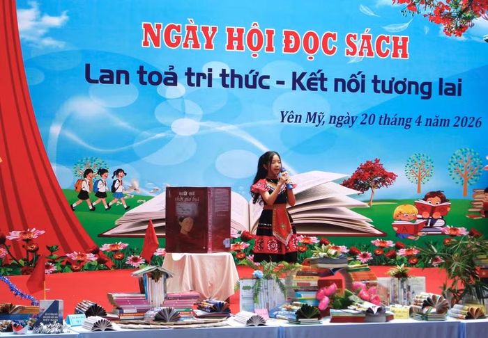 Em Nguyễn Ngọc Diệp (học sinh lớp 5A1, Trường Tiểu học Yên Mỹ I) giới thiệu cuốn sách “Nữ sĩ thời gió bụi” của nhà văn Lê Phương Liên. Ảnh: Đinh Chiến