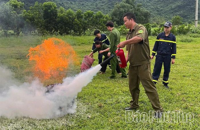 Thành viên đội an ninh trật tự ở cơ sở thực hành sử dụng phương tiện chữa cháy.