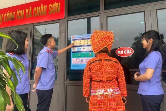  Tổ tuyên truyền dán áp phích tại trung tâm dịch vụ công ích và trực tiếp giải thích cho người dân.