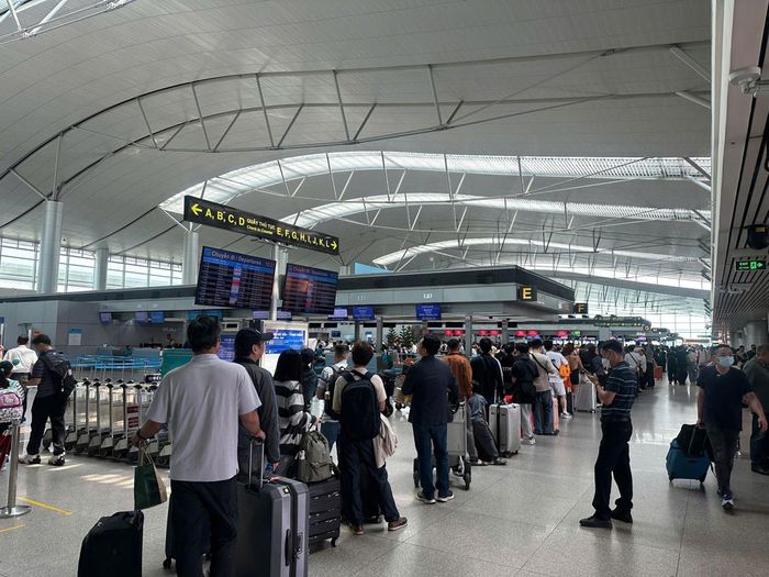Hành khách xếp hàng làm thủ tục tại nhà ga quốc tế trong sân bay Tân Sơn Nhất.