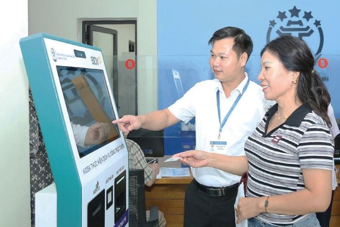 Giải quyết thủ tục hành chính cho người dân tại Trung tâm Phục vụ hành chính công thành phố Hà Nội, Chi nhánh số 8, xã Quang Minh. Ảnh: Phạm Hùng