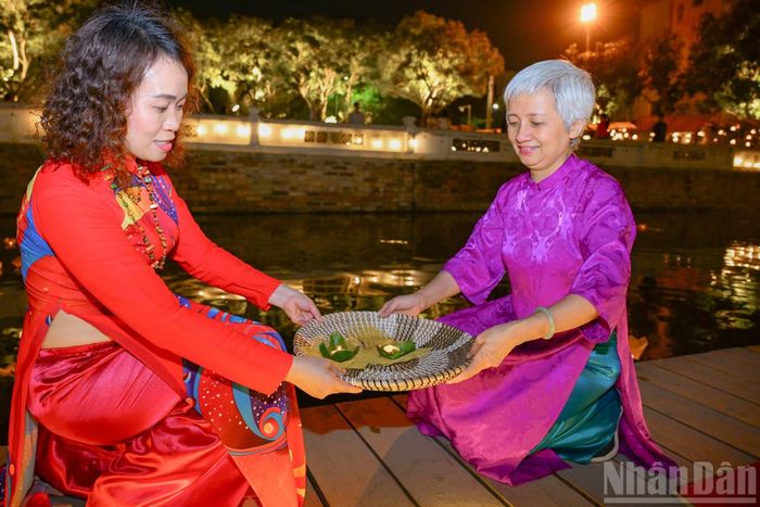 Du khách tự tay làm và thả đèn hoa đăng.