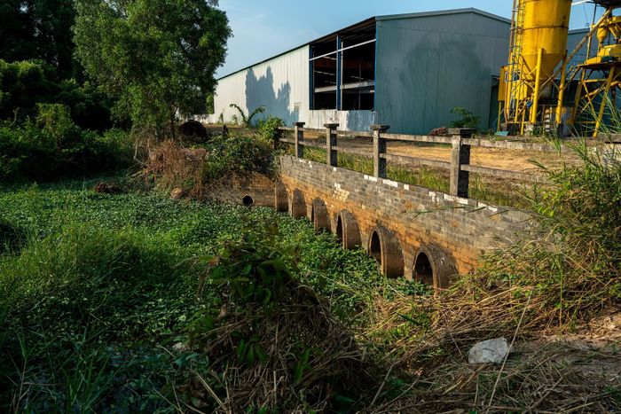 Nhiều cống thoát nước bị đắp chặn, cửa xả bị bịt kín bởi rác thải, cây dại. Ảnh: Huy Phạm