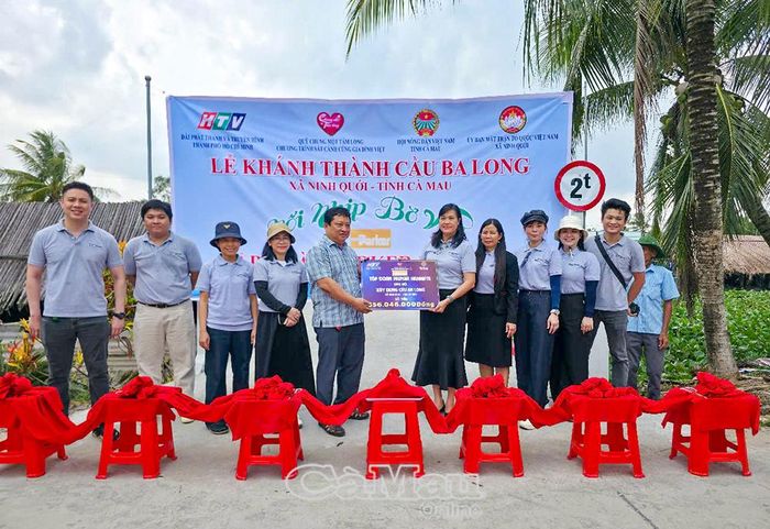Đại diện Tập đoàn Parker Hannifin trao bảng tượng trưng hỗ trợ công trình cho lãnh đạo UBND xã Ninh Quới.