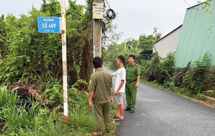 Công an xã Nhuận Đức bắt quả tang Nguyễn Đức T. dán quảng cáo sai quy định