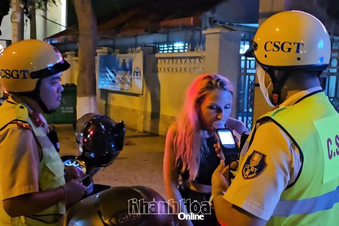Nữ du khách Mishchenko Ekaterina thổi kiểm tra nồng độ cồn.