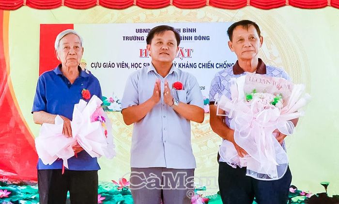 Ông Lê Minh Toàn, Phó Chủ tịch UBND xã Khánh Bình, tặng hoa cho đại diện cựu giáo viên và cựu học sinh thời kỳ kháng chiến chống Mỹ của Trường Khánh Bình năm xưa.