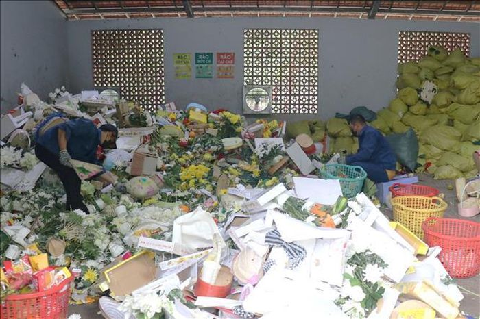 Các nhân viên Nghĩa trang Hàng Dương, Côn Đảo, TP. Hồ Chí Minh phân loại các sản phẩm tái sử dụng trái cây sau khi người dân và du khách dâng lễ. Ảnh: Thanh Vũ/TTXVN