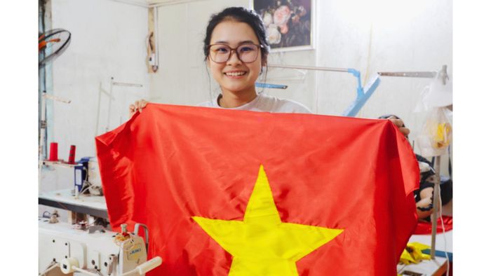 Ngọc Anh tự hào chia sẻ lá cờ mình vừa hoàn thiện. Ảnh: Cẩm Hà, Thu Trang