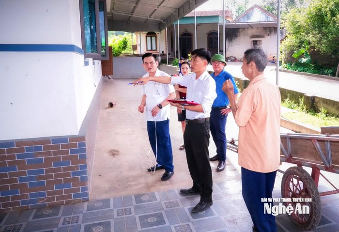 Cán bộ UBND xã Nam Đàn thực hiện công tác đo đạc, kiểm đếm tài sản trên đất cho các hộ gia đình bị ảnh hưởng. Ảnh: P.V