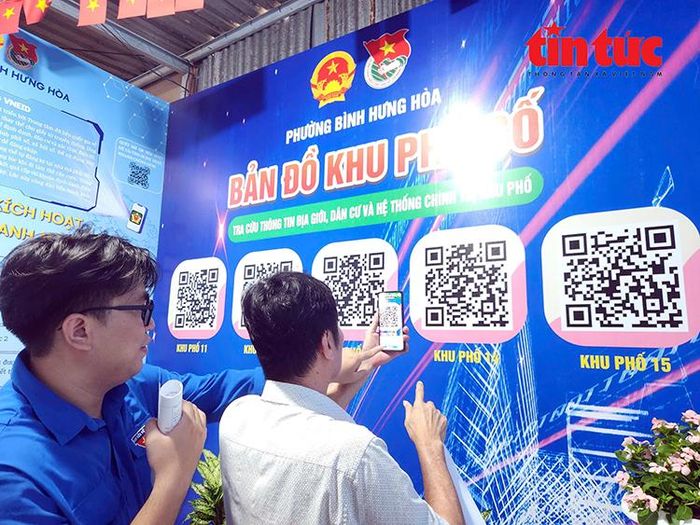 Đoàn viên thanh niên hướng dẫn người dân quét mã QR của từng khu phố.