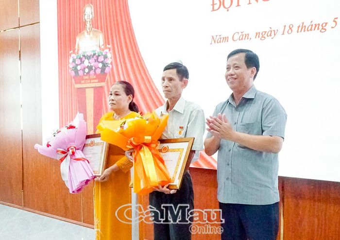 Đồng chí Huỳnh Minh Kiên, Bí thư Đảng ủy, Chủ tịch HĐND xã Năm Căn, trao Huy hiệu 40 năm tuổi đảng cho đồng chí Vũ Hải Năng (Chi bộ Ấp 7) và đồng chí Phạm Thị Ký (Chi bộ Ấp 6).