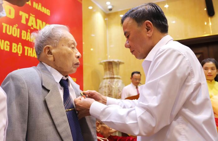 Thường trực Ban Bí thư Trần Cẩm Tú trao Huy hiệu 80 năm tuổi Đảng tặng đảng viên lão thành Trần Thanh Dân.