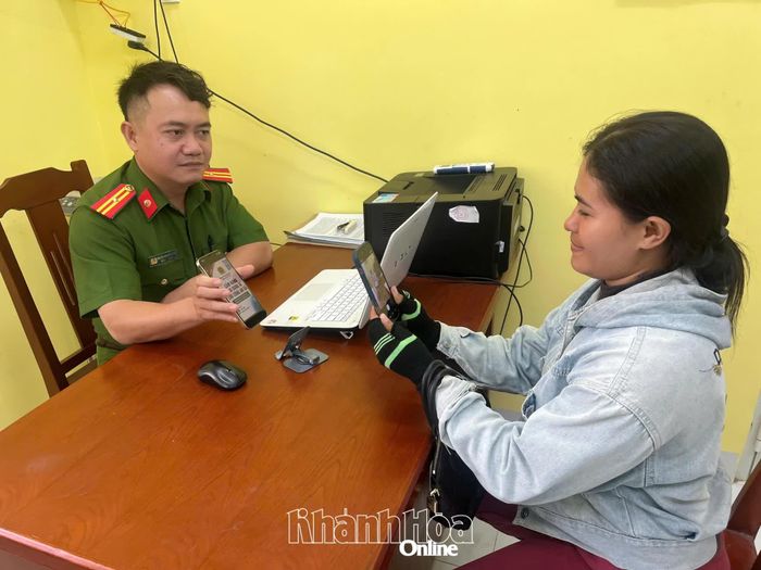  Cán bộ Công an xã Mỹ Sơn hướng dẫn người dân quét mã QR để truy cập phiên bản điện tử của “Cẩm nang ứng dụng AI cho Công an xã”. 