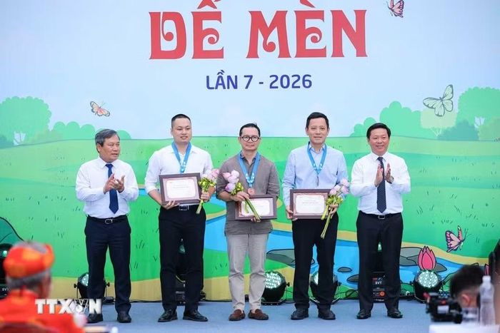 Phó trưởng Ban Tuyên giáo và Dân vận Trung ương Trần Thanh Lâm (bên phải) và Chủ tịch Ủy ban Nhân dân thành phố Hà Nội Vũ Đại Thắng trao Giải thưởng "Khát vọng Dế Mèn" cho các tác giả. (Ảnh: Hoàng Hiếu/TTXVN)