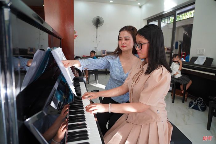  Chị Trịnh Hồng Nhung - Giám đốc Trung tâm đào tạo nghệ thuật Gmusic (phường Thành Sen) hướng dẫn các học viên học đàn piano. 