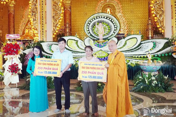 Chùa Phật Quốc Vạn Thành trao bảng tượng trưng tặng 500 phần quà cho phường Bình Long và phường An Lộc. Ảnh: Văn Tâm