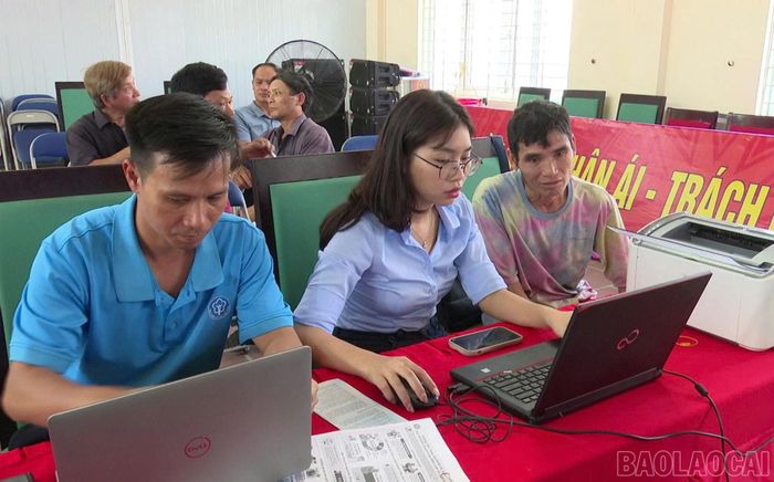 Cán bộ bảo hiểm xã hội hỗ trợ người dân kê khai hồ sơ, hoàn thiện thủ tục ngay tại UBND xã.