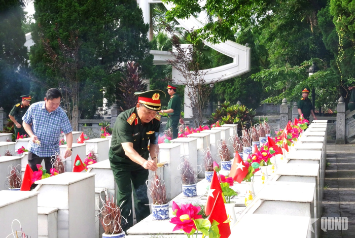 Trung tướng Vũ Kim Hà, Phó giám đốc Học viện Quốc phòng và các đại biểu thắp hương tại phần mộ các Anh hùng liệt sĩ ở Nghĩa trang Liệt sĩ Vị Xuyên. 