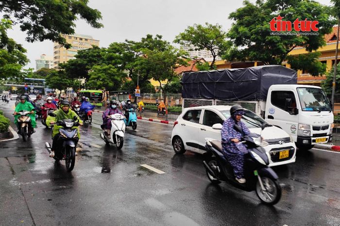 Từ sáng sớm, nhiều người dân TP Hồ Chí Minh đã phải mặc áo mưa đi làm, khác với tình trạng nắng nóng kéo dài những ngày trước đó.