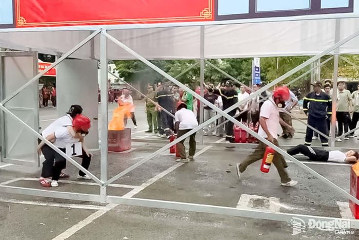 Thành viên các đội thi Cụm thi số 2 thực hành sử dụng bình chữa cháy xách tay xử lý tình huống cháy giả định. Ảnh: CTV