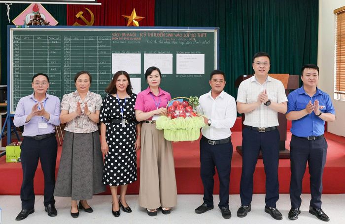 Lãnh đạo xã Đại Xuyên tặng hoa, gửi lời chúc tốt đẹp tới Hội đồng thi. Ảnh: Hồng Nhung