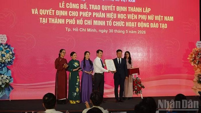 Giáo sư, Tiến sĩ Lê Quân, Thứ trưởng Bộ Giáo dục và Đào tạo trao Quyết định thành lập Phân viện Học viện Phụ nữ Việt Nam tại Thành phố Hồ Chí Minh cho Ban giám đốc Học viện.