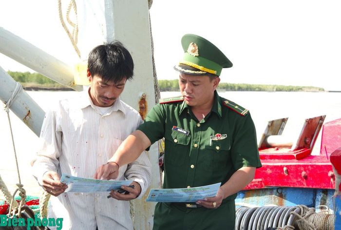Cán bộ Đồn Biên phòng Rạch Gốc kiểm tra thiết bị giám sát hành trình trên tàu cá của ngư dân. Ảnh: Lê Khoa
