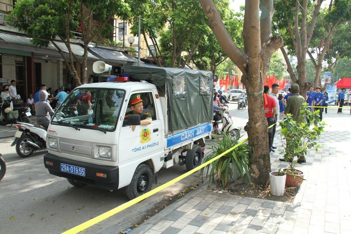 Cùng với các đoàn viên thanh niên, lực lượng Công an phường cũng túc trực để phân luồng giao thông giữ gìn an ninh trật tự tại khu vực cổng trường. Ảnh: Cao Kỳ