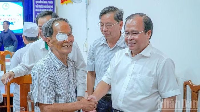Phó Chủ tịch Ủy ban nhân dân tỉnh Cà Mau Nguyễn Minh Luân (bìa phải) hỏi thăm sức khỏe bệnh nhân vừa xong việc phẫu thuật mắt miễn phí.