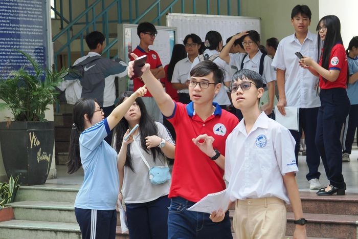  Tình nguyện viên hỗ trợ thí sinh tìm phòng thi trước Kỳ thi tuyển sinh vào lớp 10 THPT năm học 2026-2027 tại điểm thi Trường THPT Lương Thế Vinh, phường Cầu Ông Lãnh. ẢNH: HOÀNG HÙNG. 