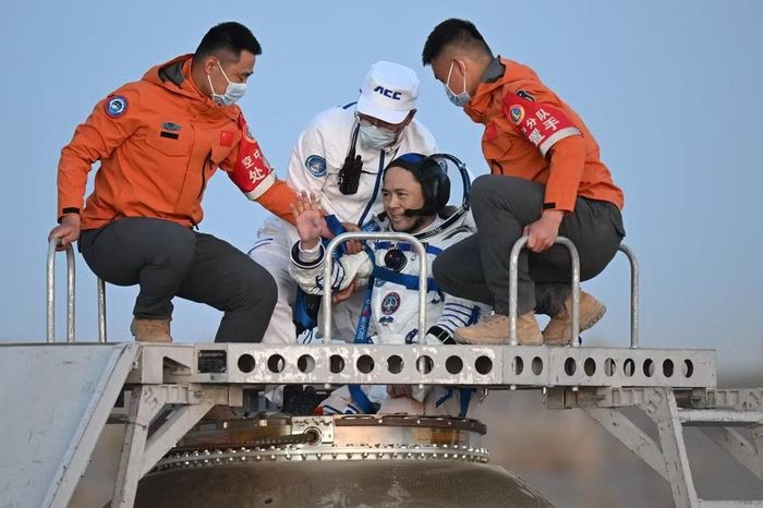 Phi hành gia Zhang Lu, chỉ huy phi hành đoàn Thần Châu 21, vẫy tay khi được đưa ra khỏi khoang tàu sau khi hạ cánh thành công xuống bãi đáp Đông Phong ngày 29/5/2026. Ảnh: Lian Zhen/Xinhua/AP.