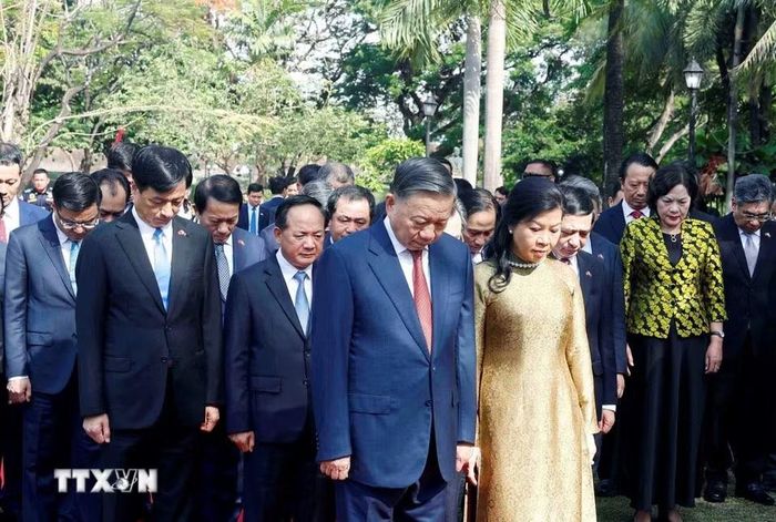 Tổng Bí thư, Chủ tịch nước Tô Lâm và Phu nhân cùng đoàn đại biểu cấp cao Việt Nam kính cẩn tưởng niệm Chủ tịch Hồ Chí Minh trước Tượng đài của Người trong Công viên ASEAN, thành cổ Intramuros. (Ảnh: Thống Nhất/TTXVN)