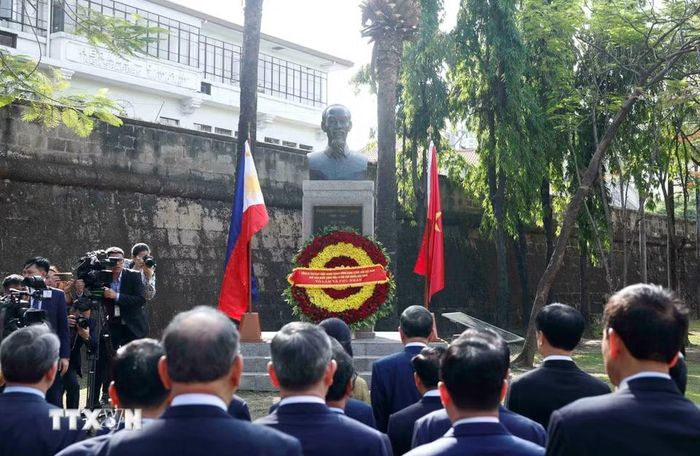Tổng Bí thư, Chủ tịch nước Tô Lâm và Phu nhân cùng đoàn đại biểu cấp cao Việt Nam dâng hoa tại Tượng đài Chủ tịch Hồ Chí Minh trong Công viên ASEAN, thành cổ Intramuros. (Ảnh: Thống Nhất/TTXVN)