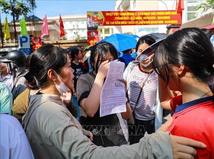 Phụ huynh chia sẻ cảm xúc với thí sinh sau khi hoàn thành môn thi Ngoại ngữ tại điểm thi trường THCS Ngô Quyền (phường Bạch Mai). Ảnh: Khánh Hòa/TTXVN