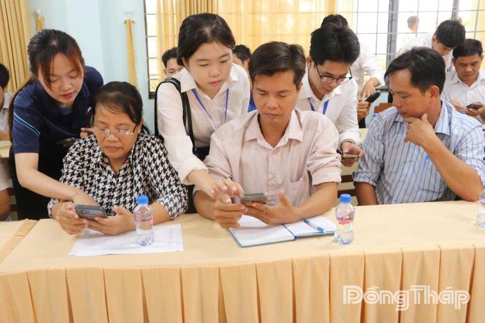 Thành viên Tổ công nghệ số cộng đồng xã Bình Hàng Trung hướng dẫn người dân sử dụng điện thoại thông minh, thực hiện các tiện ích số và dịch vụ công trực tuyến trong quá trình chuyển đổi số tại địa phương.
