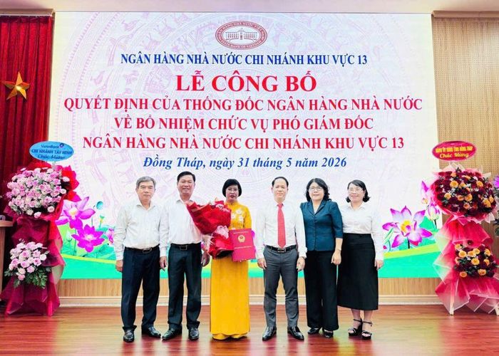 Đồng chí Phạm Văn An, Phó Bí thư Đảng ủy UBND tỉnh Đồng Tháp và đồng chí Phạm Minh Tú, Giám đốc NHNN chi nhánh Khu vực 13 trao Quyết định bổ nhiệm giữ chức vụ Phó Giám đốc NHNN Khu vực 13 và tặng hoa chúc mừng đồng chí Bùi Thị Thúy Hằng.