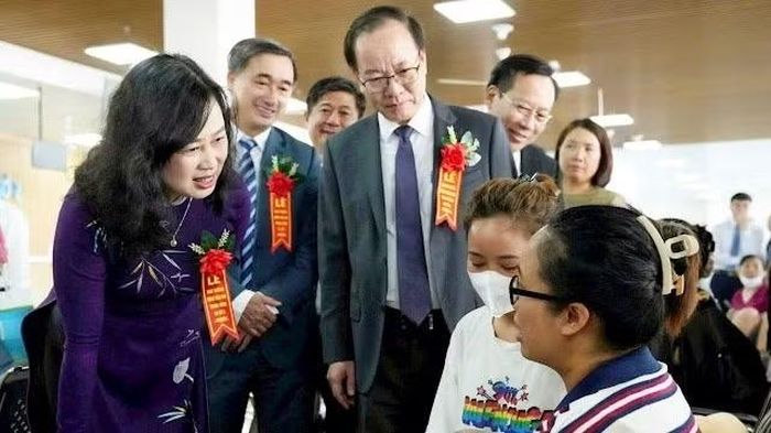 Người đứng đầu ngành y tế trao đổi với các bà mẹ đưa con đến khám bệnh tại cơ sở 2 của Bệnh viện Nhi Trung ương.
