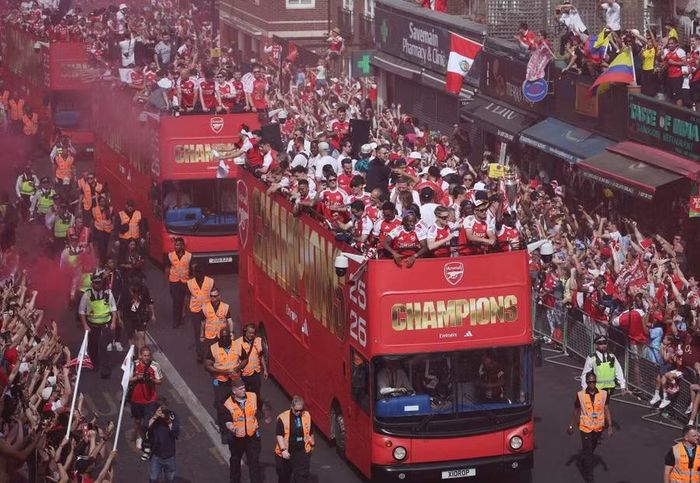 Xe buýt mui trần chở các thành viên Arsenal nối đuôi nhau đi qua những tuyến phố đông nghịt người. Hàng trăm ngàn CĐV từ nhiều nơi đổ về Bắc London để chia vui cùng đội bóng.